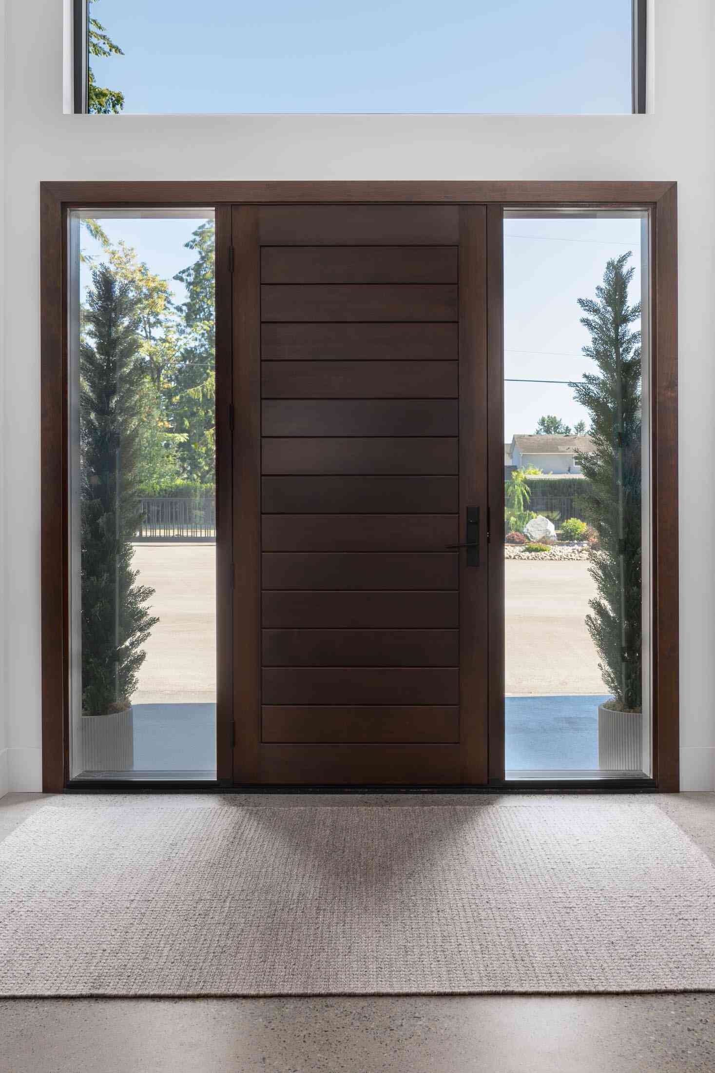 Oversized wood front door with sidelights